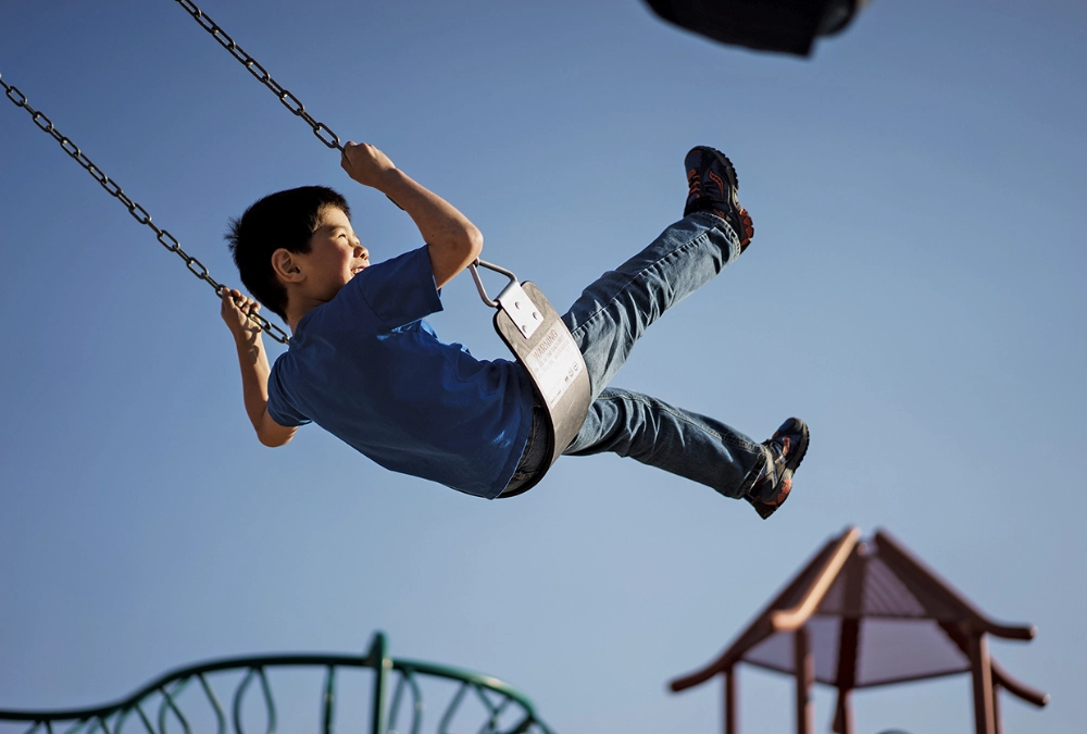 Child playing on a swing